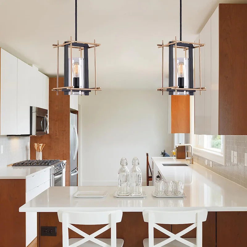 Suspension Braum à une lumière, cage métallique rectangulaire noir mat et bronze doré, abat-jour cylindrique en verre transparent.